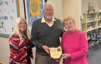Mrs. Jean Brush, Mr. Geoffrey Kent, and Mrs. Jennifer Felker pictured with an award